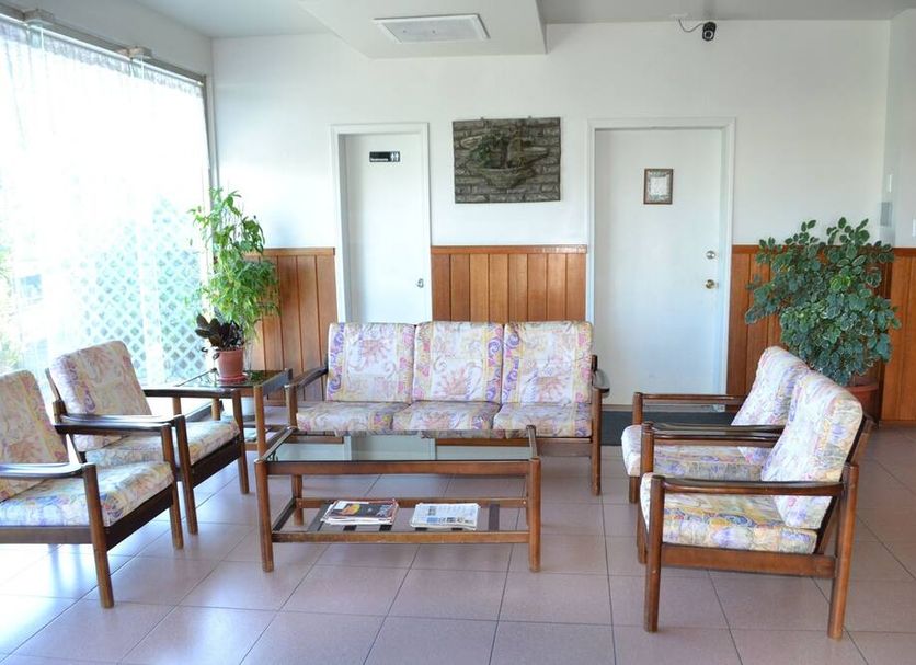 West Plaza Downtown lobby in Koror with seating area, coffee table, plants and tiled floors