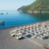 Ekincik Beach Hotel in Ekincik with a seaside beach setup, loungers, umbrellas, and calm bay views