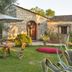 Villa dei Papiri in Siracusa: stone villa with garden patio, table and chairs, umbrella, and sun loungers