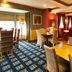 Premier Inn Rugeley restaurant with dining tables, upholstered chairs and warm lounge-style seating