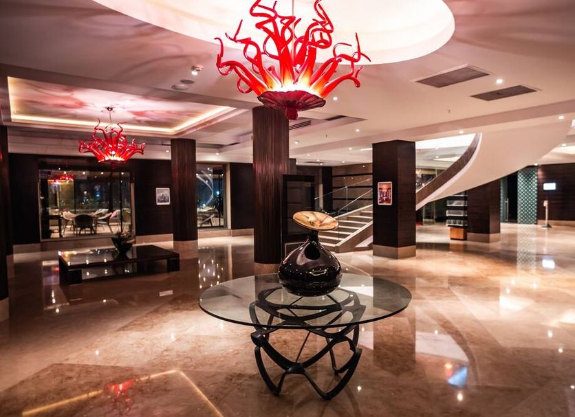 Çelik Palace Hotel Convention Center & Thermal Spa lobby in Bursa with red chandelier and marble floors