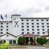 Golden Tulip Kumasi City in Kumasi with flagpoles and hotel facade