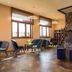 Hotel Olympia in Bruges lounge with seating, fireplace feature wall and large windows