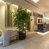 Una Hotels Villa Dei Platani Foligno lobby with marble reception desk and indoor plants
