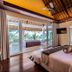 Seven Secrets by Hanging Gardens Senggigi bedroom with balcony and palm tree view