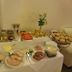 Weserlounge Hotel Garni breakfast buffet with sandwiches, cold cuts, fruit, eggs and pastries in Hessisch Oldendorf