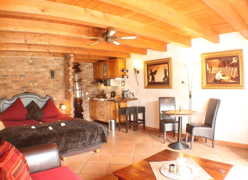 Hazienda Apartmenthotel in Gernsbach room with bed, dining table and kitchenette