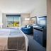 Shutters Hotel in Elko guest room with king bed, armchair, TV and window view