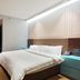Gem Hotel Nanjing Dachang Xinhua Road Pedestrian Street guest room with double bed and wood flooring