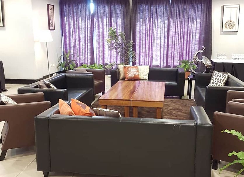 Paddy's Hotel & Apartments in Port Moresby lounge with leather seating and a wooden coffee table