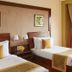 The Retreat Hotel & Convention Centre in Mumbai: twin beds, window seating, and garden view