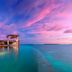 Milaidhoo Maldives in Kamadhoo, beachfront overwater villa with infinity pool at sunset