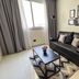 Cyan Recoleta Hotel in Buenos Aires room with black sofa, coffee table, wall art and window with curtains