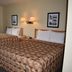 Murphy's Alaskan Inn in Seward guest room with two beds and window view of trees