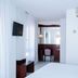 Hotel Plaça in Sant Feliu de Guíxols guest room with bed, TV, desk and air conditioning