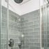 Casa Chitic in Braşov bathroom shower with green tile walls and glass sliding doors