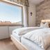 Mineralienhotel Natznerhof in Natz-Schabs, bright guest room with large bed and mountain view