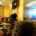 Hotel Orizzonte in Letojanni: elegant lounge with leopard-print chair, glass table, and wall mirror