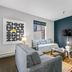 The Oxford at Pike Place Market, Seattle guest room with bed, sofa, armchair, TV and colorful rug