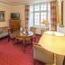 Romantik Parkhotel Wasserburg Anholt in Isselburg hotel room with striped seating and round table