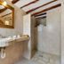 Agroturismo Ca Sa Vilda Marge in Sant Joan de Labritja bathroom with stone sink, mirror and walk-in shower
