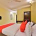 OYO 2494 Hotel Shree Plaza room in Bharūch with double bed, wall-mounted TV and wardrobe