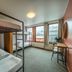 Loft - Hi Eco Hostel in Reykjavik dorm room with bunk beds, desk, and city-view windows