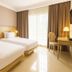 Nims Hotel Seminyak, Kuta: bright twin room with two beds, desk, and floor-to-ceiling window
