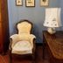 Agriturismo Rio Verde, Sasso Marconi: vintage armchair, table lamp, and framed botanical art on blue wall