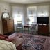 Moseley Cottage Inn and The Town Motel in Bar Harbor, guest room with seating, TV, and tall windows