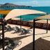 Sea of Cortez Beach Club in San Carlos with beach loungers and shaded pergola beside the ocean