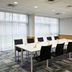 Meeting room at Portsmouth Marriott Hotel in Portsmouth with a long conference table and black chairs