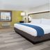 Holiday Inn Express & Suites Blackwell By IHG room with king bed, desk, TV and city-view window