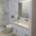 The Passage - Urban & Lifestyle Hotel Basel bathroom with glass shower, sink vanity and toilet