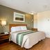 HomeTowne Studios by Red Roof Denver - Lakewood West guest room with bed, kitchenette and wood flooring