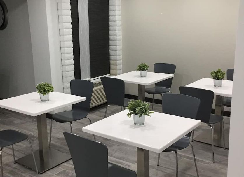 Days Inn & Suites by Wyndham Cincinnati North seating area with tables and chairs in Cincinnati