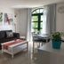 La Venecia de Canarias Puerto de Mogan living room with sofa, coffee table, dining set and garden-view window in Mogán