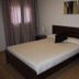 Águilas de los Collados room in Águilas with double bed, bedside tables and curtains