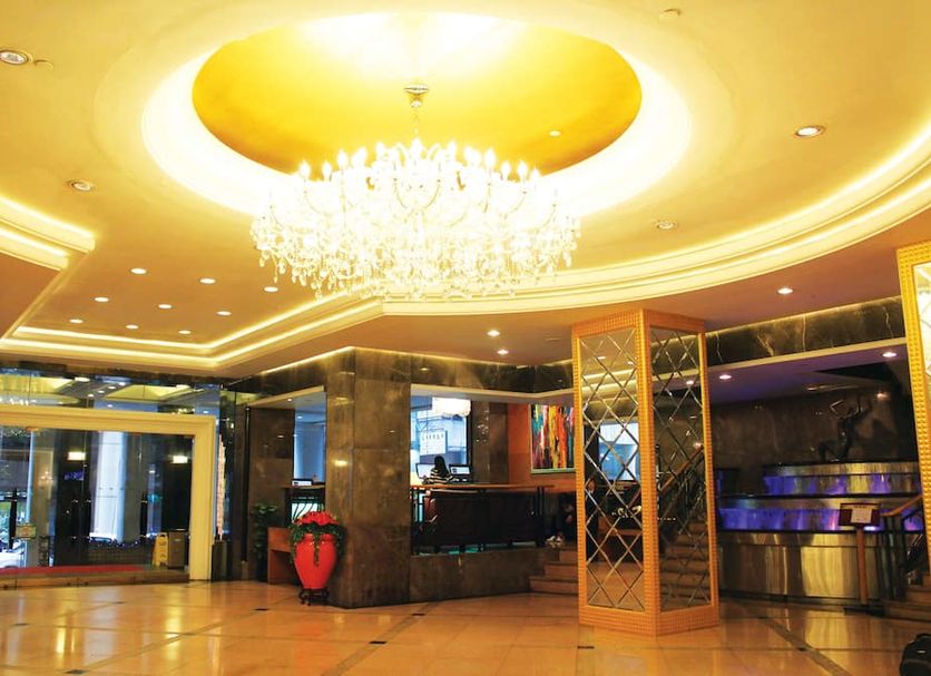 Metropark Hotel Macau lobby with chandelier, gold-lit ceiling, marble columns and glass entrance in Macau