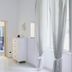 Sfumature Partenopee Naples room with white walls, dresser, bed rail and window with sheer curtains