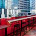 citizenM Austin Downtown rooftop bar with red counter stools and city views in Austin