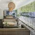 Hotel Neo + Kuta Legian lobby lounge with wicker seating, hanging pendant lights and greenery in Kuta