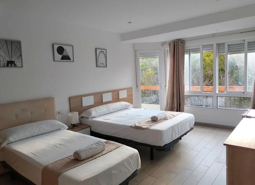 Pension Portugal Alicante twin room with large windows and balcony view