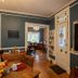 5 Ojo Inn Bed & Breakfast in Eureka Springs dining room with chandelier, wood floors, and doorway to dining area