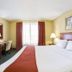 Holiday Inn Express & Suites Brooksville West by IHG guest room with king bed and desk