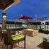 Home2 Suites by Hilton Anchorage/Midtown rooftop patio with striped seating and fire pit in Anchorage