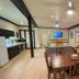 Wells Gray Inn in Clearwater suite with dining table, kitchenette, sofa, and wall-mounted TV
