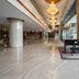 Hua Bin International Hotel Beijing lobby with grand chandeliers, piano and polished marble floors