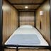 Funny Guesthouse in Ho Chi Minh City, compact pod-style single bed with wood-paneled walls