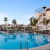 Ramada by Wyndham Dalaman poolside with palm trees and a large outdoor swimming pool